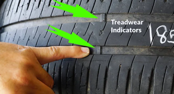 Tire treadwear indicators show that the treads are vanished and expired